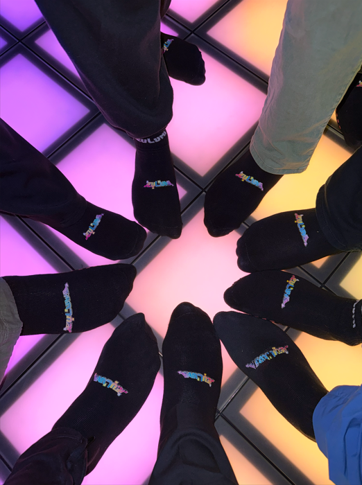 Players standing in a circle on the glowing jeuLumi floor